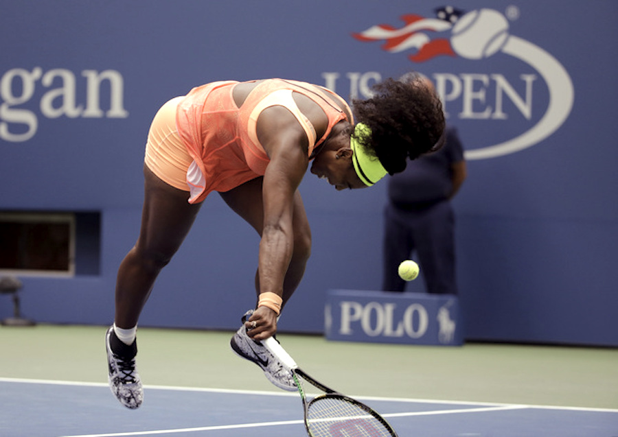 Serena Williams stumbles as she fails to catch up with a drop shot from Roberta Vinci, of Italy, during a semifinal match at the U.S. Open tennis tournament, Friday, Sept. 11, 2015, in New York. (AP Photo/David Goldman)